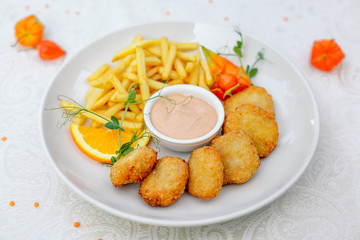 nuggets with French fries and sauce