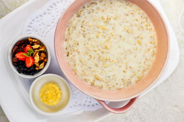 breakfast, oatmeal with butter, berries and orange juice
