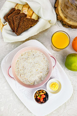 breakfast, oatmeal with butter, berries and orange juice