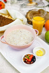 breakfast, oatmeal with butter, berries and orange juice