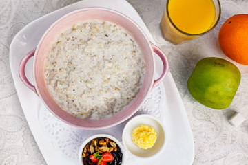 breakfast, oatmeal with butter, berries and orange juice