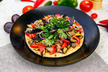 salad with meat greens and vegetables grilled on a wheat cake with smoke