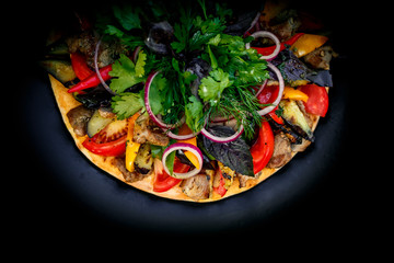 Fototapeta na wymiar salad with meat greens and vegetables grilled on a wheat cake with smoke