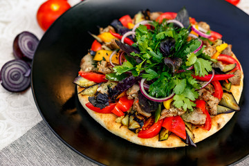salad with meat greens and vegetables grilled on a wheat cake with smoke