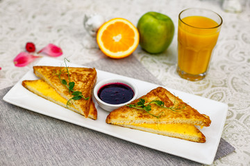 Toast with cheese and raspberry jam for breakfast