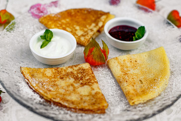 pancakes with powdered sugar berries and jam for breakfast