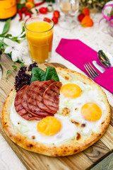 Bacon and eggs on a wheat cake with greens for lunch