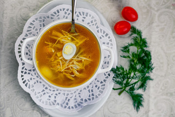 chicken soup with noodles and eggs with vegetables serving for lunch