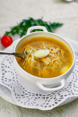 chicken soup with noodles and eggs with vegetables serving for lunch