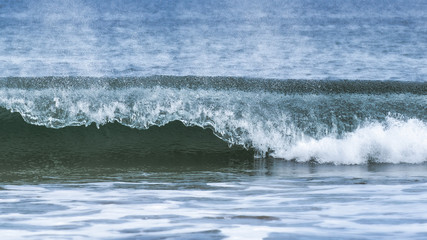 Breaking wave, green ocean, spray and surf
