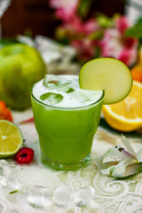 cocktail with apple and fruit on background