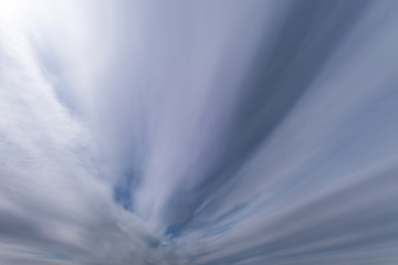Blue sky background with tiny stratus cirrus striped clouds. Clearing day and Good windy weather
