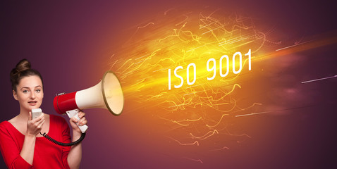 Young girld shouting in megaphone with ISO 9001 inscription, online shopping concept