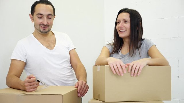Young couple relocating into a new house and discussing their palns about design and future goals.
