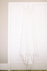 Wedding dress hanging on the wardrobe.