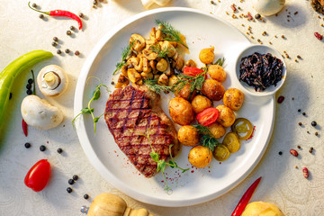 delicious steak with mushrooms and baked potatoes with jalapeno, healthy food