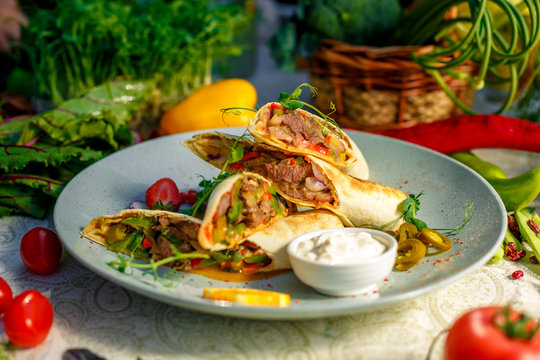 Traditional Mexican Food - Burrito, on white wooden retro table