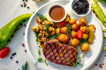 delicious steak with mushrooms and baked potatoes with jalapeno, healthy food