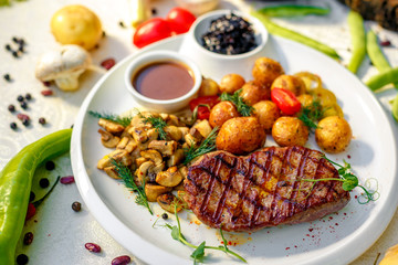 delicious steak with mushrooms and baked potatoes with jalapeno, healthy food