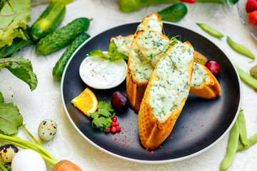appetizing garlic bread with cheese and fresh vegetables