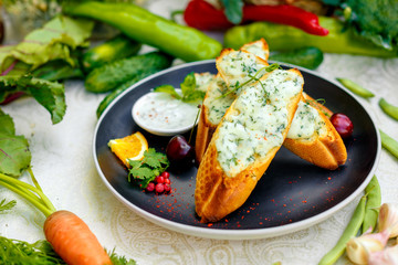 appetizing garlic bread with cheese and fresh vegetables