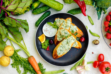 appetizing garlic bread with cheese and fresh vegetables