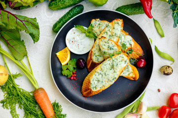 appetizing garlic bread with cheese and fresh vegetables
