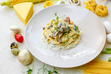 Spaghetti Carbonara - pasta with smoked bacon and mushrooms in creamy sauce and Parmesan cheese