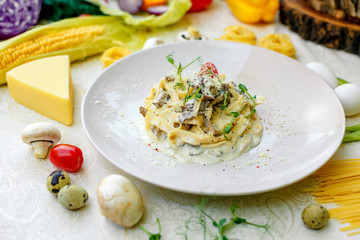 Spaghetti Carbonara - pasta with smoked bacon and mushrooms in creamy sauce and Parmesan cheese