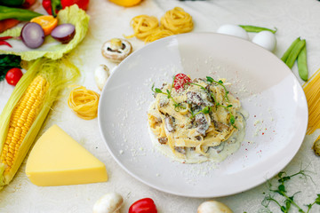 Spaghetti Carbonara - pasta with smoked bacon and mushrooms in creamy sauce and Parmesan cheese