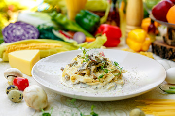 Spaghetti Carbonara - pasta with smoked bacon and mushrooms in creamy sauce and Parmesan cheese