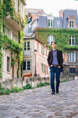 Obraz na płótnie Canvas a man in a jacket and jeans walks in Montmartre, Paris