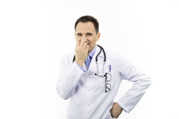 Middle aged handsome doctor in white coat and stethoscope looking skeptic and scared, nervously bitting nails because of problems, isolated white background, healthcare, protection concept