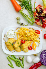 Breaded chicken with French fries and sauce