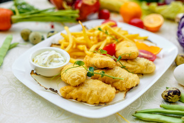 Breaded chicken with French fries and sauce