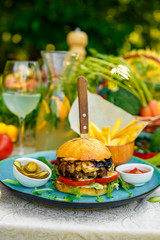 cheese mushroom burger with french fries jalapeno and sauce, outside