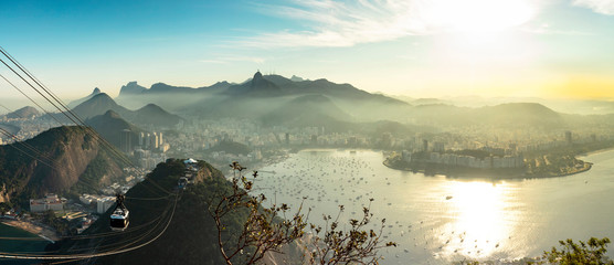 Aerial panorama of Guanabara Bay, statue of Christ the Redeemer and Sugar Loaf Mountain at sunset,...