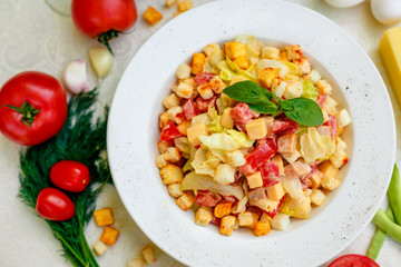 fresh salad with chicken, cheese, rusks, lettuce and tomatoes