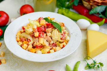fresh salad with chicken, cheese, rusks, lettuce and tomatoes