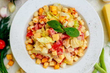 fresh salad with chicken, cheese, rusks, lettuce and tomatoes