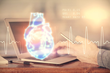 Double exposure of man's hands holding and using a phone and heart drawing. Medical education...