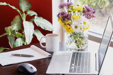 cup of coffee and notebook and flowers