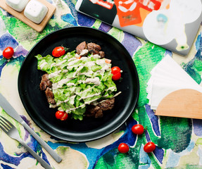 fried meat pieces topped with salad