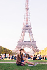 girl sitting in Paris against the backdrop of the Eiffel tower
