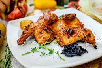 fried chicken grilled with onion and hot pepper on a decorated table