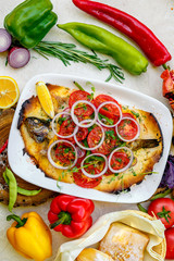 hot smoked fish koktal, Kazakh dish, with vegetables, tomatoes and onions on a festive table, special dish