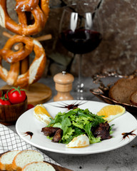 fried meat with herbs and glass of wine