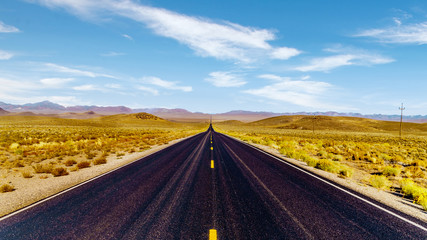 The quiet, long and straight Extraterrestrial Highway, Nevada SR 375, which runs along Area 51 between Crystal Springs and Warm Springs in the semi desert desolate land in Nevada, United States