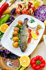 Grilled trout with potato sauce and tomato sauce and jalapeno