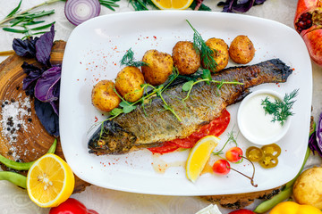 Grilled trout with potato sauce and tomato sauce and jalapeno